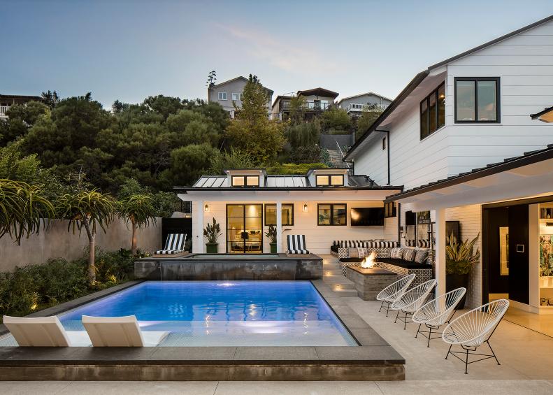 A Modern Backyard Features a Swimming Pool and Sitting Areas