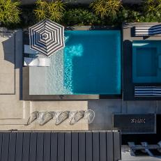 An Overhead View of a Modern Backyard Features a Swimming Pool, Hot Tub and Various Lounge Areas Located Throughout the Outdoor Space