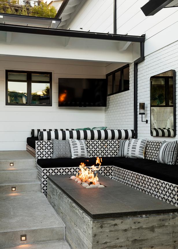 A Patio Features a Built-in Bench That Surrounds a Modern Fire Pit