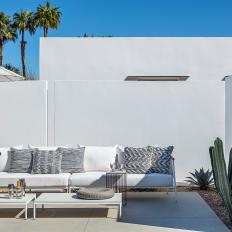 A Contemporary Patio Features Low-Profile Lounge Furniture, Privacy Walls and Water-Wise Landscaping That Showcases Cacti and Other Plant Varieties
