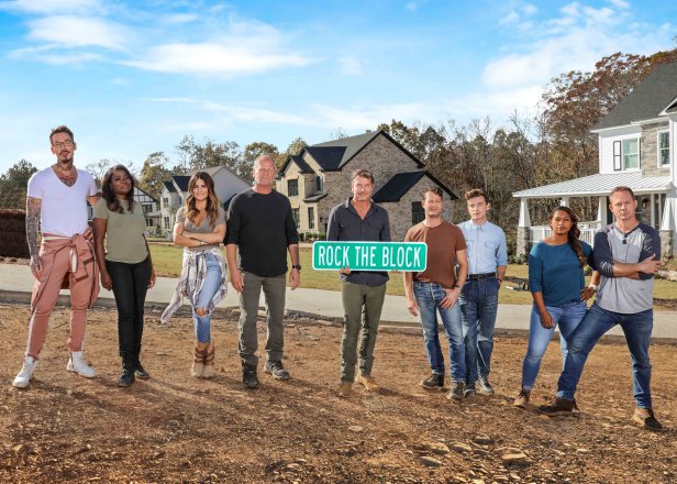 As seen on HGTV’s Rock the Block season 2, the cast and host Ty Pennington poses with the houses in the background.