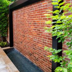 Steel Water Feature and Brick Wall