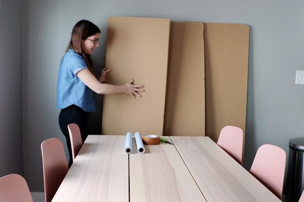 Karen Kavett Holding Cardboard Panel