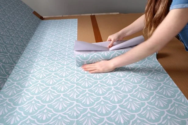 Karen Adding Blue Contact Paper to Cardboard Panels 