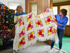 From left, host Lara Spencer talks with appraiser Jacquie Denny while holding a blanket crocheted by Wendy Baker's mom at Wendy's childhood home in Montville, New Jersey, while walking through the home to determine what should be put up for auction, as seen on Everything But The House.(action)