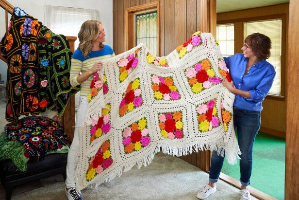 From left, host Lara Spencer talks with appraiser Jacquie Denny while holding a blanket crocheted by Wendy Baker's mom at Wendy's childhood home in Montville, New Jersey, while walking through the home to determine what should be put up for auction, as seen on Everything But The House.(action)