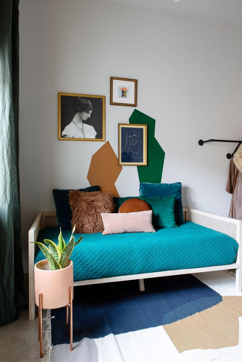 Geometrically Painted Wall Above Colorful Caned Daybed