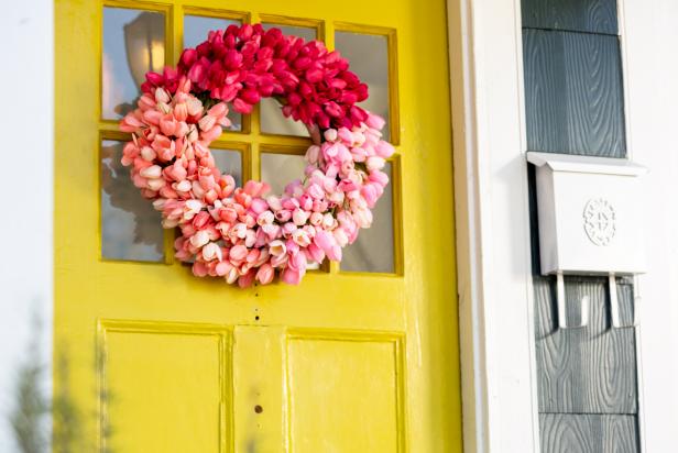 Vibrant Spring Tulip Wreath Hangs on Yellow Front Door