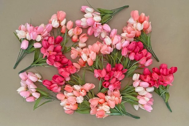 Groups of Tulip Bouquets in Similar Pink Hue on Work Table