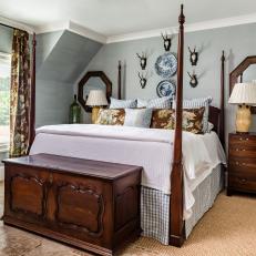 Traditional Blue Bedroom With Dark Wooden Furniture and Four Poster Bed 