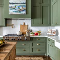 Traditional Farmhouse Kitchen With Green Cabinets and Artwork 
