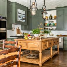 Traditional Farmhouse Kitchen With Green Cabinets and Pine Island 
