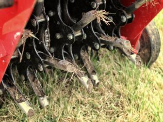 Close up of a mechanical lawn aerator.