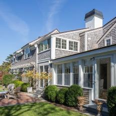 Cape Cod Style Home With Cedar Siding and White Trim