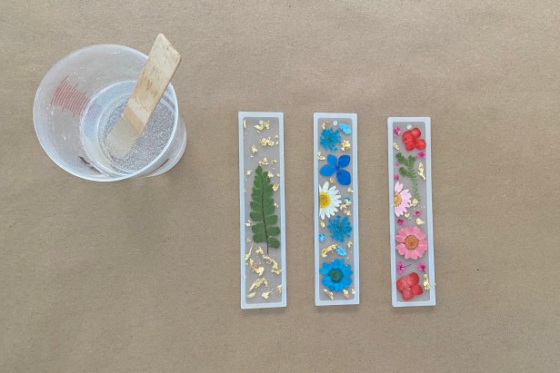 Once the resin is mixed according to the instructions, gently pour a thin layer of resin into one mold at a time. Tip: if the flowers move around, simply adjust with the tweezers. After you pour, add a little more resin to any areas that need little more resin.