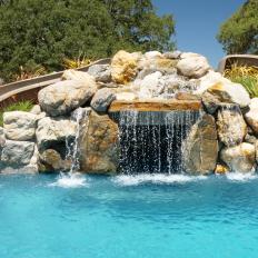 Two Slides Enter Pool Around Waterfall From Pool Kings