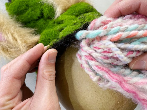 Man gluing yarn to the egg