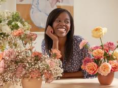 Smiling Woman Poses With Bouquets of Carnations, Roses and Peonies