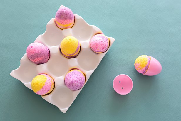 HGTV Handmade's Jill Tennant shows you how to make this cute, colorful Easter egg bath bomb in minutes. To make, you will need 12 plastic egg molds, an egg carton, four large bowls, a spray bottle, a whisk, spoon and fork, witch hazel, baking soda, epsom salt, citric acid, cornstarch, fractionated coconut oil, plant-based food coloring and essential oil.