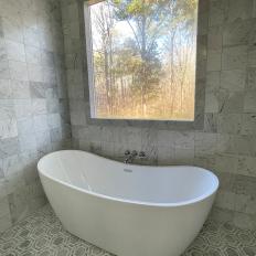 Soaking Tub With Gray Geometric Floor