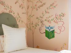 White bed with green headboard and mural with bird reading a book.