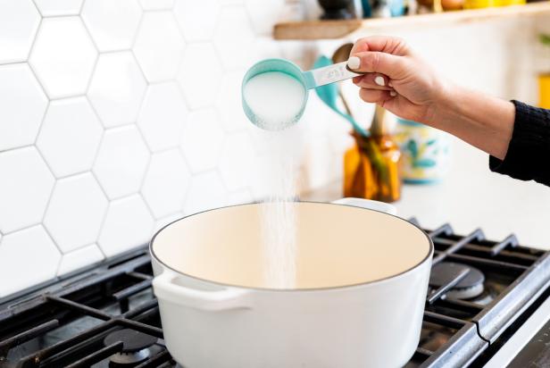 In a saucepan, add 1 cup of flour, 2 teaspoons of cream of tartar and 1/2 cup of salt.  Add food coloring to 1 cup of water to avoid staining hands later. Then pour the water and food coloring into the mixture. Next, add 1 TBS vegetable oil . Turn the burner on medium/low and stir the mixture . Stir with a whisk until the mixture starts to become solid, or when it starts to become thick and lumpy. Once the dough starts sticking together and pulling away from the sides of the pan it's done.
