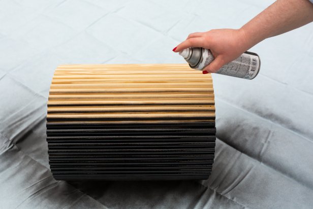 Spray paint the base of the table using matte black spray paint. Add two coats to ensure full coverage.