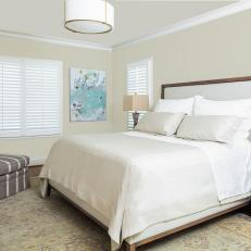 Neutral Transitional Bedroom With Striped Armchair