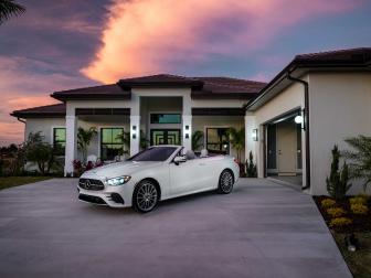 A convertible with sporty luxury and the latest in technology for driver support, part of the thrilling HGTV Smart Home 2021 prize package, sits in front of this versatile two-car garage with organized storage for tools, and a surprise "she shed" that offers a cozy spot to get away from it all.