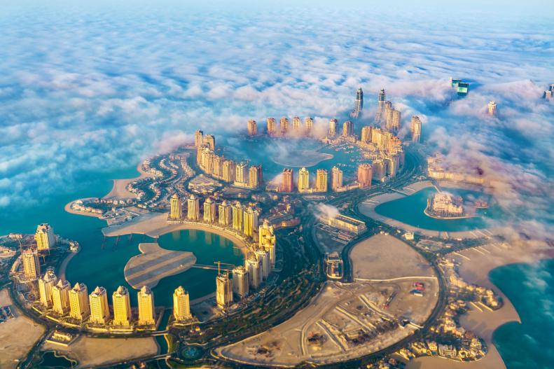 Morning light reflects off of modern skyscrapers in Doha, Qatar