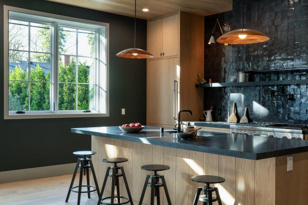 This kitchen includes black counters and backsplash.