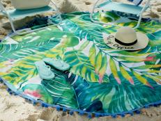 Blue and green beach blanket in the sand 