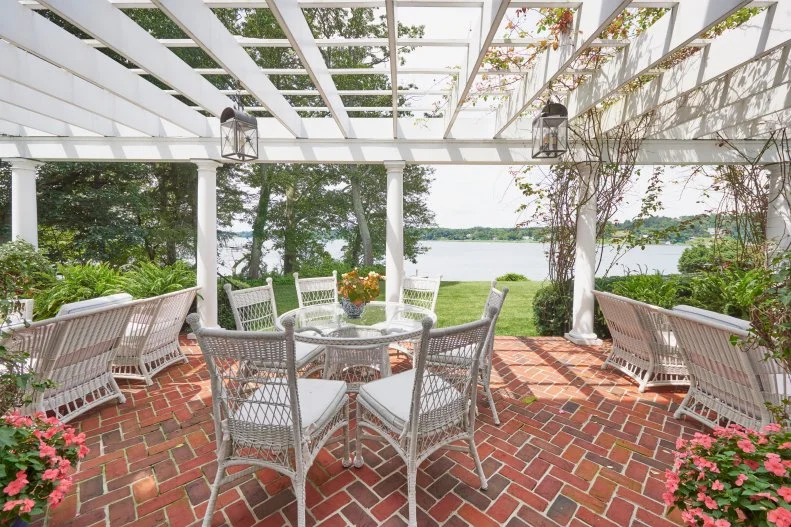 A Riverview Patio in Herringbone Brick With White Pergola Awning