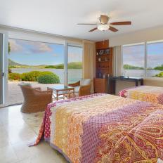 Tropical Bedroom With Red and Yellow Linens