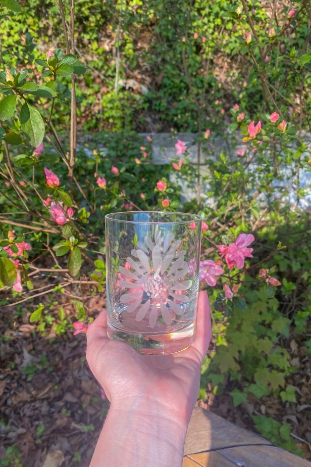 Hand Holds Finished Etched Floral Rocks Glass Outside