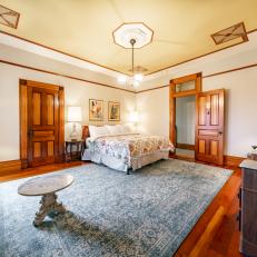 Expansive Bedroom Features Tray Ceilings and Traditional Trim
