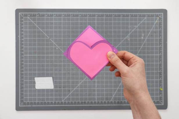 Once the glue is dry, flip the card over and fold each side backwards. Then you should be able to fold each half into the center to make a small square.