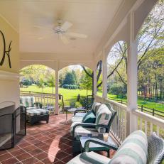 Covered Porch With Outdoor Fireplace and Lounge Furniture