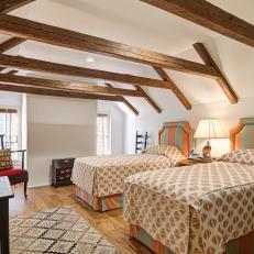 Attic Bedroom Features Exposed Beams and Matching Twin Beds