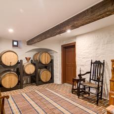 Rustic Cellar Features an Exposed Wood Beam and Wood Barrels 