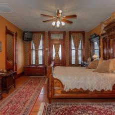 Orange Victorian Bedroom With Red Rugs