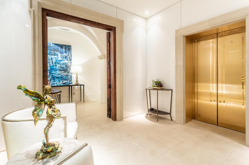 Private Elevator in Gold Finish Opens to Penthouse Foyer, Chairs