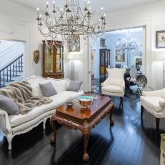 Sitting Room Features Antique Lounge Furniture and an Ornate Chandelier