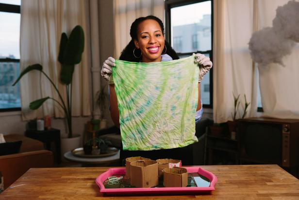 HGTV Handmade's A.V. Perkins shares four techniques to tie-dye cotton napkins with ice. To make your own, you will need: powder fabric dye, cotton napkins, ice, scrap cardboard, rubber bands, a roasting rack, container lid and protective gloves.