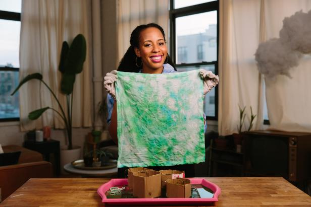 HGTV Handmade's A.V. Perkins shares four techniques to tie-dye cotton napkins with ice. To make your own, you will need: powder fabric dye, cotton napkins, ice, scrap cardboard, rubber bands, a roasting rack, container lid and protective gloves.