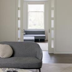 Living Room With Gray Sofa and Pocket Doors