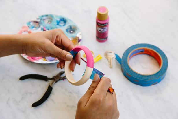 Once the paint on the wooden ring is completely dry, remove the painter's tape.