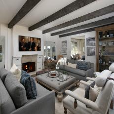 Cozy Entertainment Space with Dark Hand-Hewn Ceiling Beams