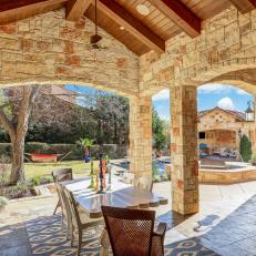 Stone Dining Patio Features Vaulted Wood Ceiling
