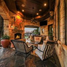 Covered Poolside Patio With Fireplace and Television